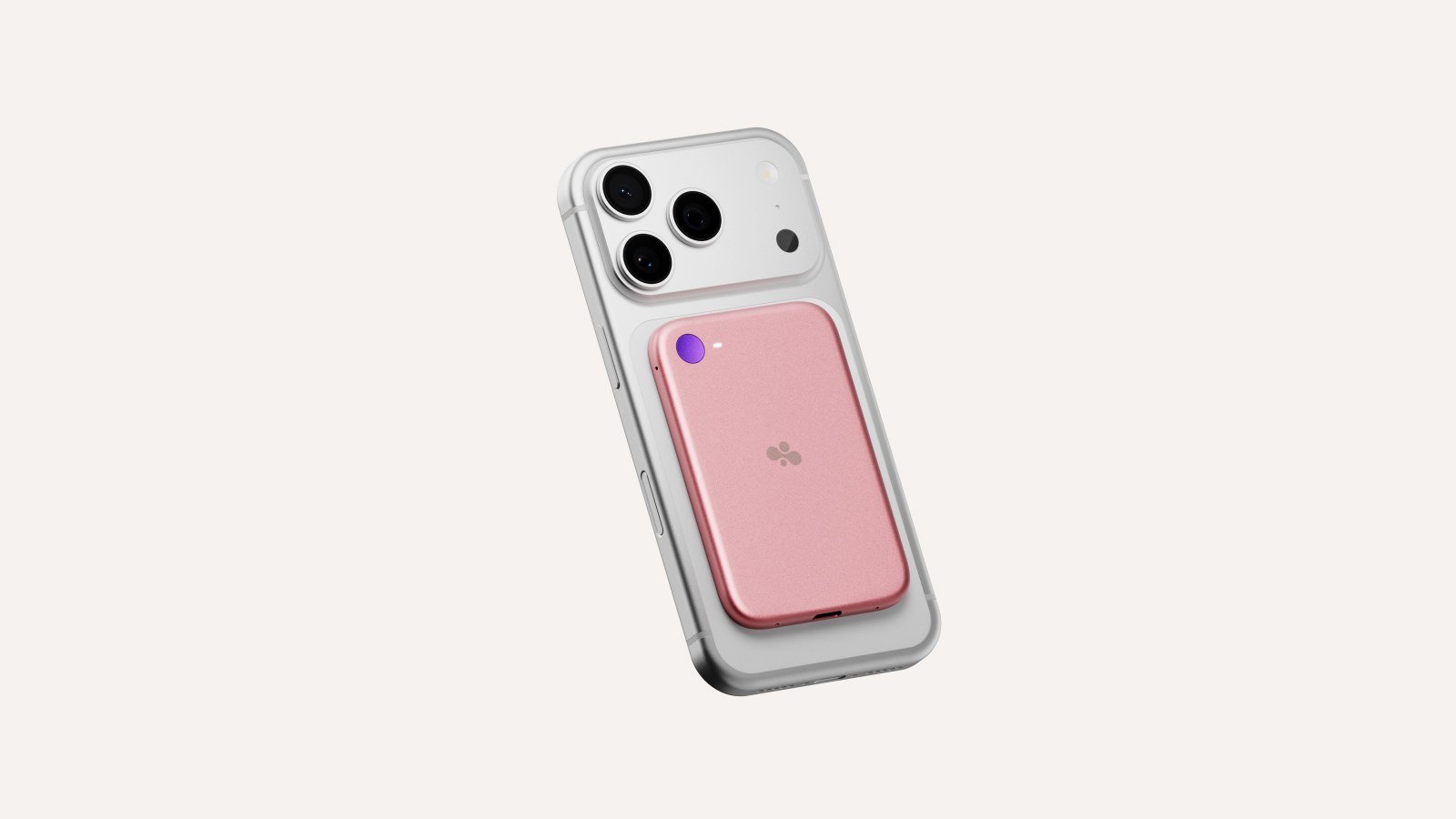 A pink Bee Eclipse attached magnetically to the back of a silver smartphone