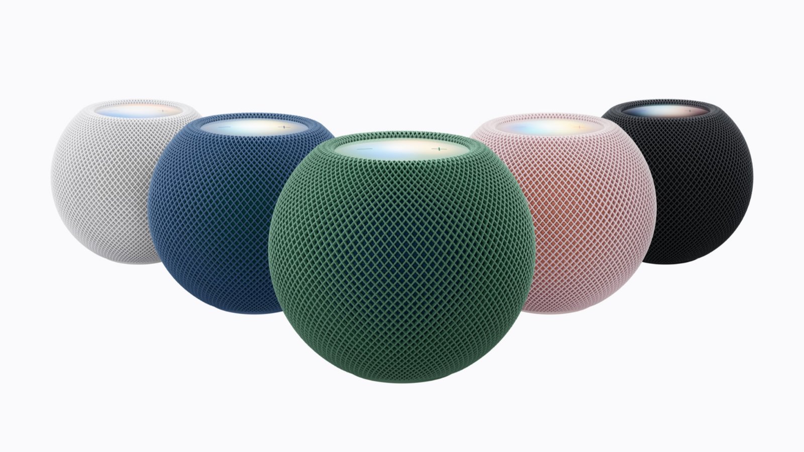 Five HomePod mini 2 speakers in white, blue, green, pink, and midnight, arranged in a V with the green one in front