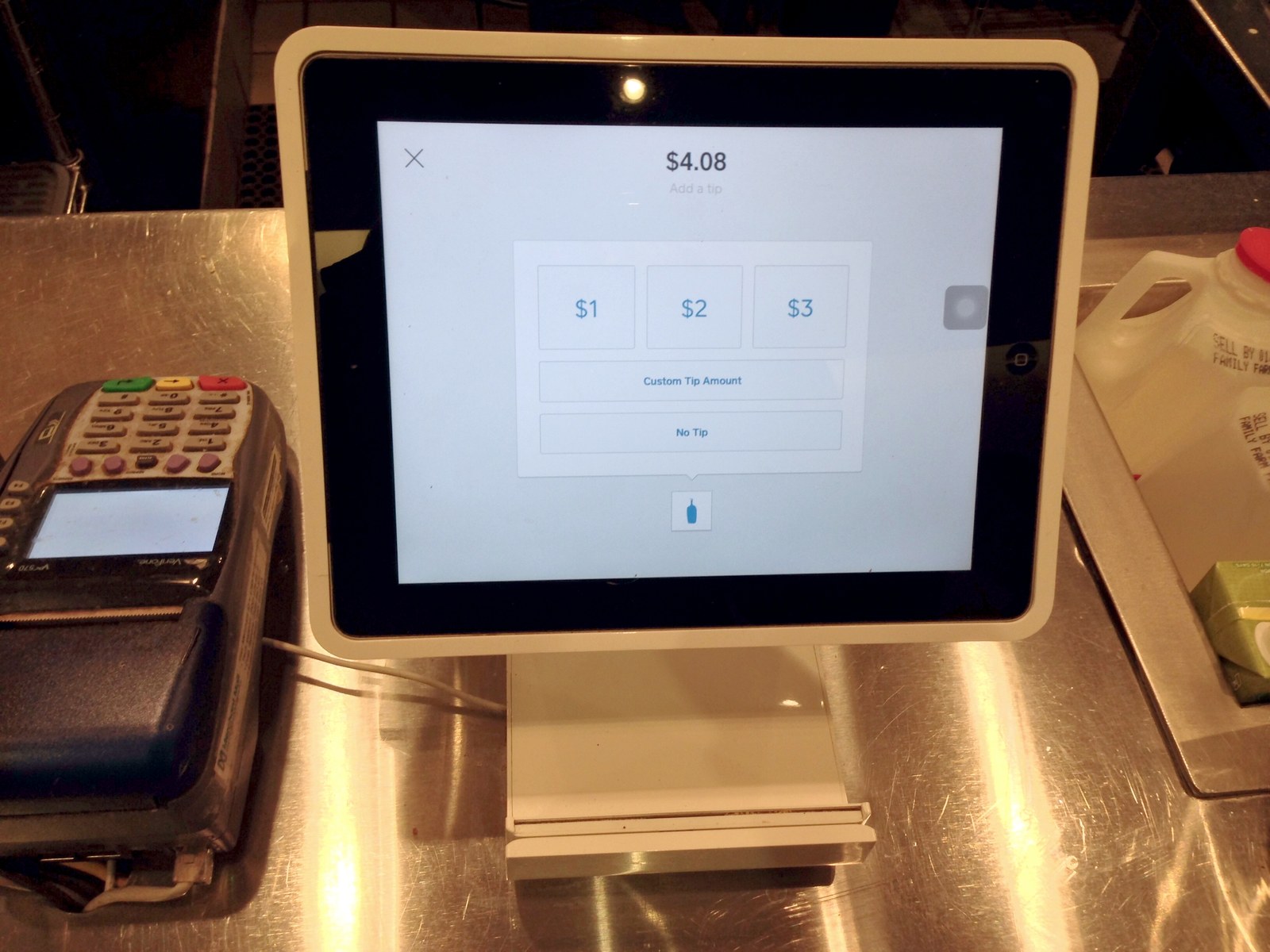 A Square Stand holding an iPad as a point-of-sale terminal on a coffee shop counter