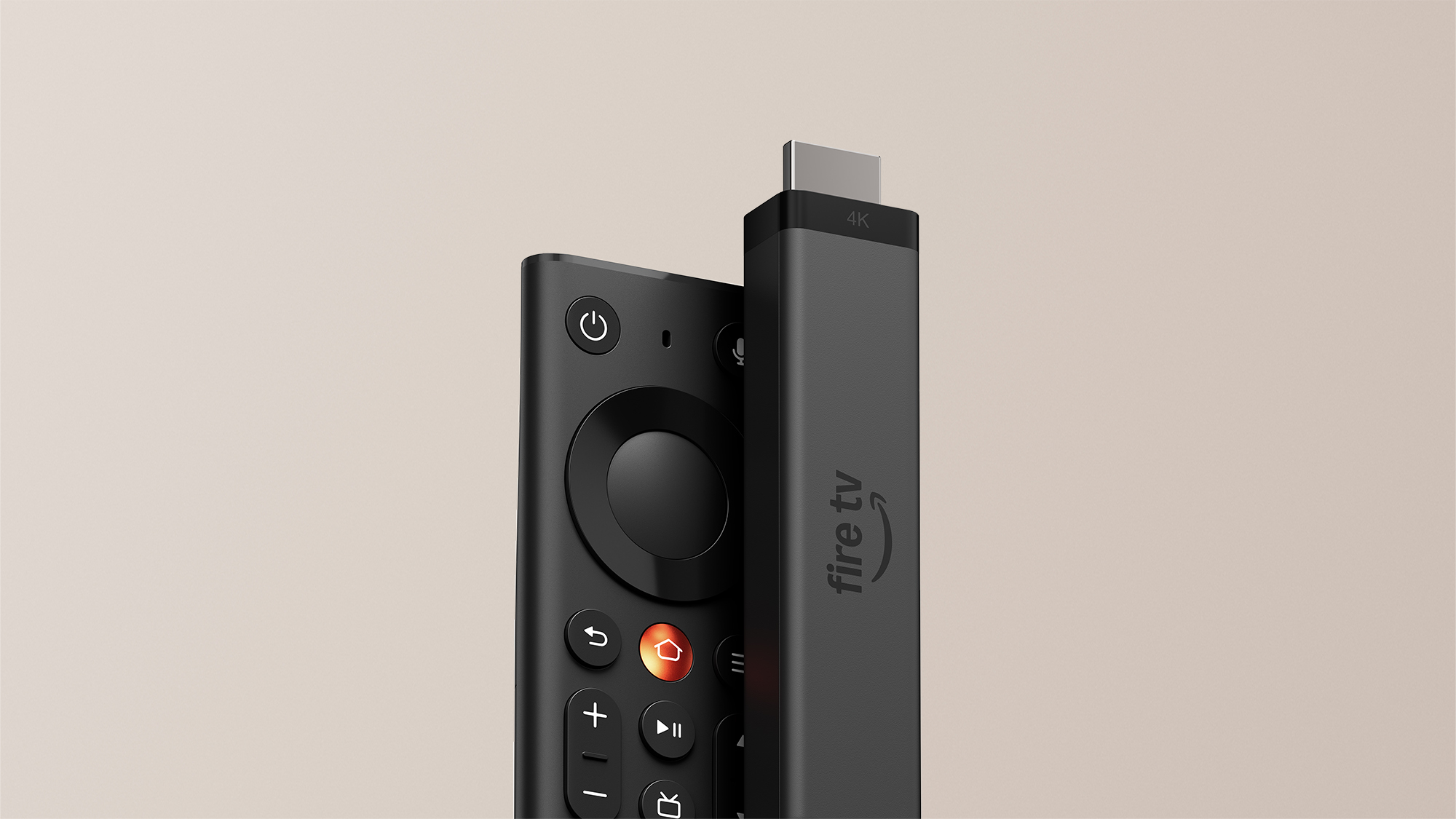 The new Amazon Fire TV Stick 4K, the slimmer 2026 body, with the redesigned Fire TV Remote beside it