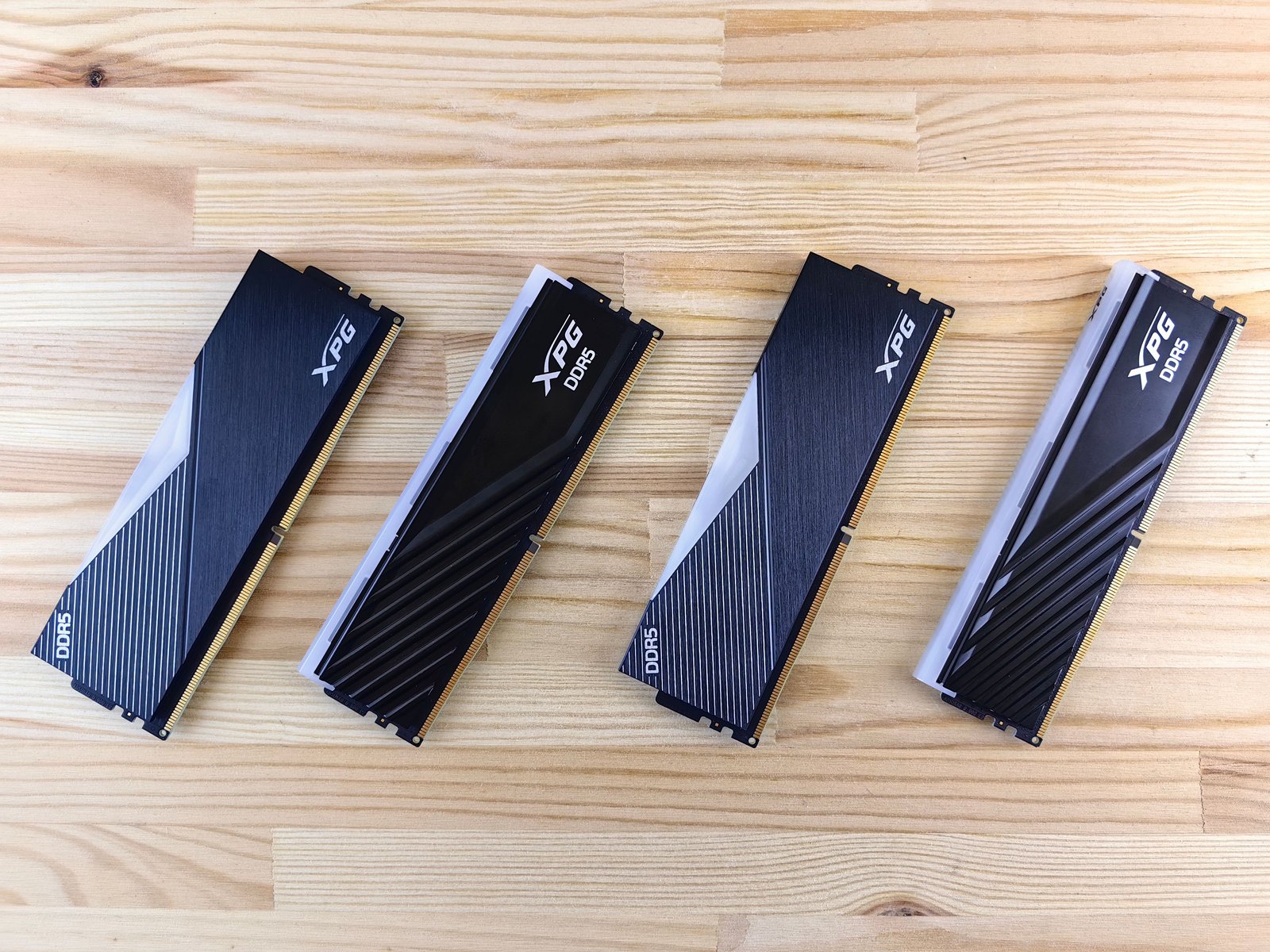 DDR5 memory modules laid flat in a row on a wooden surface